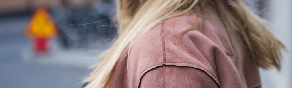 woman with long hair wearing shoulder covering jacket