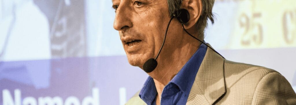 man stands in front of presentation with microphone